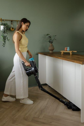 Evomax stick vacuum cleaner in use